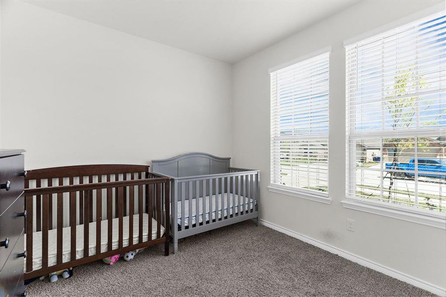 Bedroom featuring carpet flooring and baseboards