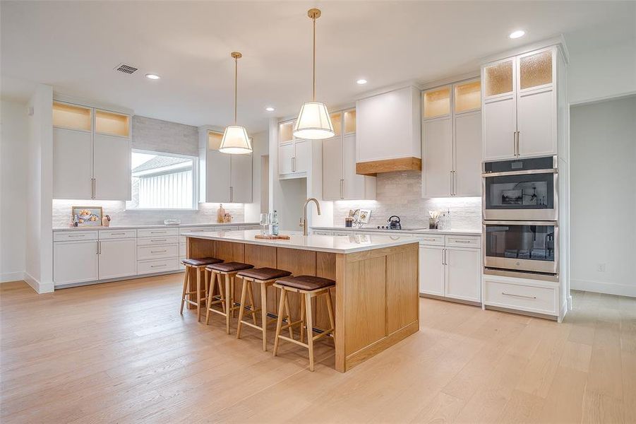 kitchen with stain grade isalnd and vent hood band kitchen with stain grade isalnd and vent hood band