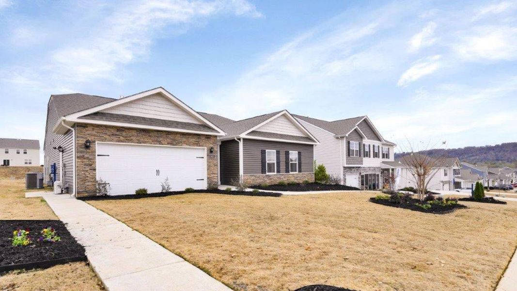 Front exterior of a new home in Sweet Briar, Ooltewah, TN, highlighting curb appeal (Image 2). Front exterior of a new home in Sweet Briar, Ooltewah, TN, highlighting curb appeal (Image 2).