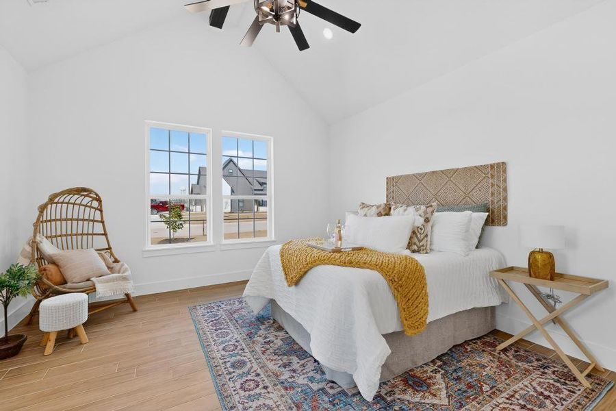 Primary Bedroom with light wood-type flooring, a ceiling fan, lofted ceiling, and recessed lighting