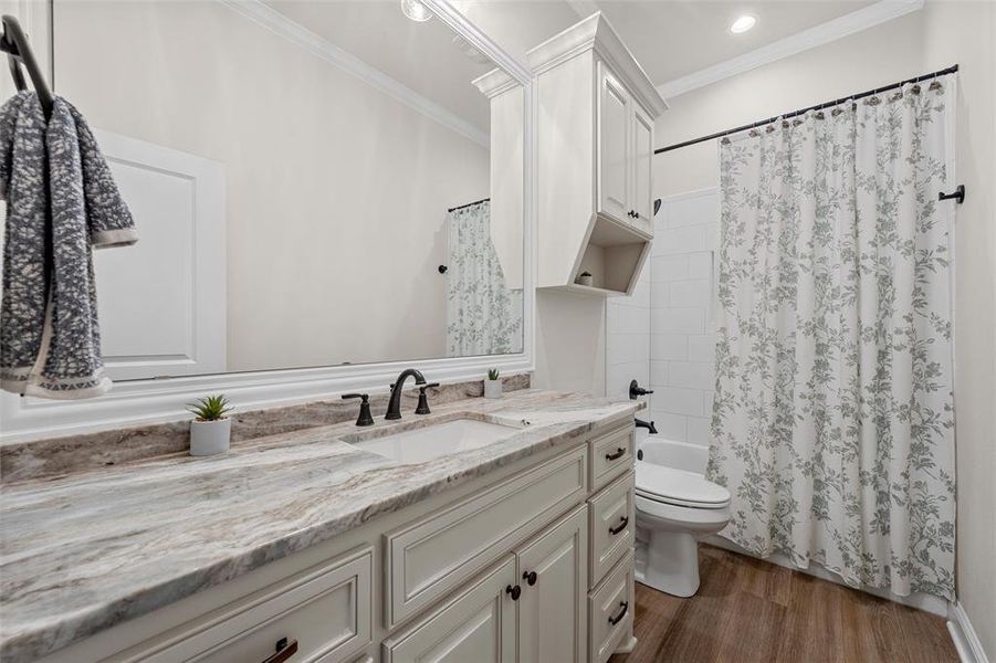 Bathroom with spacious vanity, granite countertop, and tub/shower combo with a tile finish. Bathroom with spacious vanity, granite countertop, and tub/shower combo with a tile finish.
