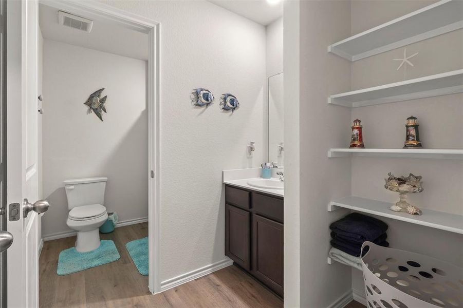 Bathroom with light wood finished floors and vanity