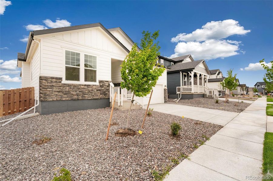 Front exterior of a new home in Turnberry, Commerce City, CO, highlighting curb appeal (Image 20).