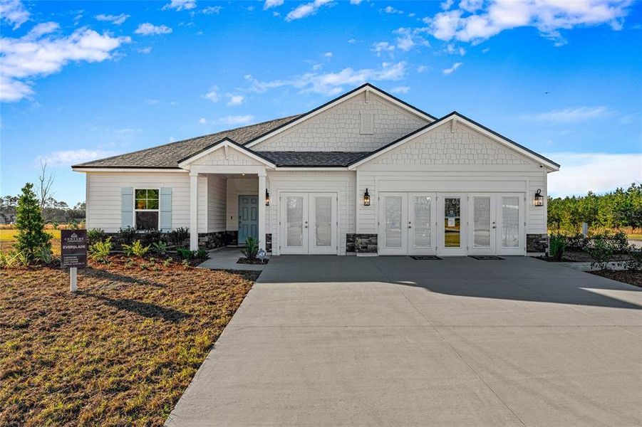 Front exterior of a new home in The Cypress Series at Reserve East, Flagler Beach, FL, highlighting curb appeal (Image 2). Front exterior of a new home in The Cypress Series at Reserve East, Flagler Beach, FL, highlighting curb appeal (Image 2).
