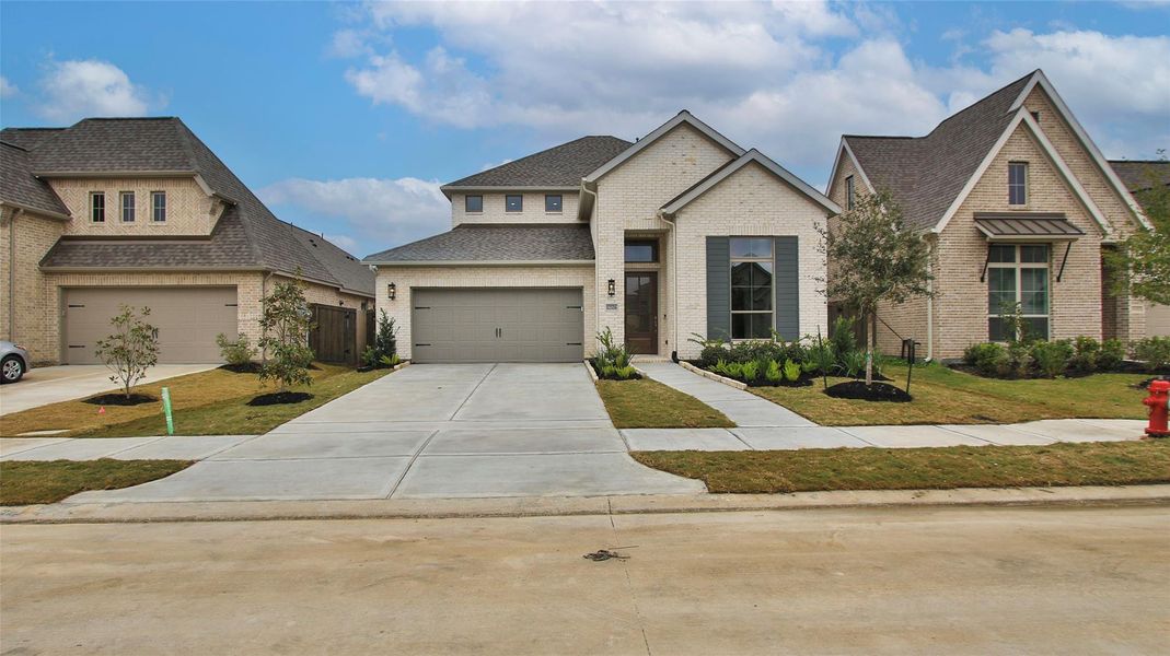 Front exterior of a new home in Riceland, Mont Belvieu, TX, highlighting curb appeal (Image 2).