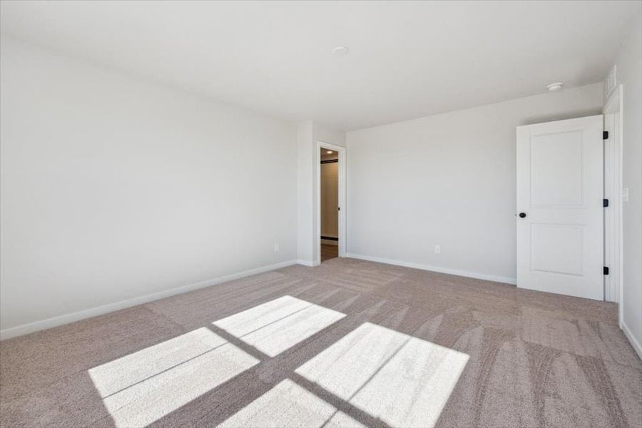 A room with white walls and a rug.