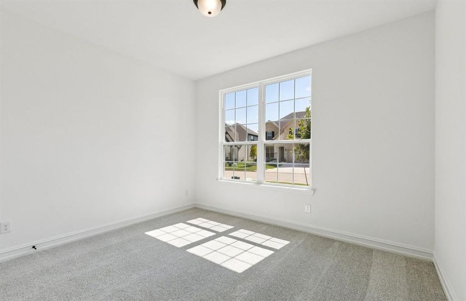 Spacious secondary bedroom with large windows