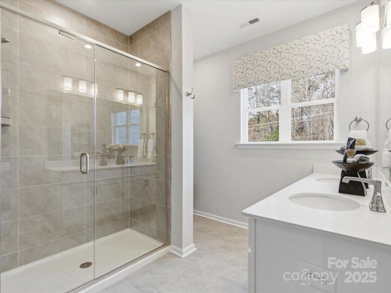En Suite Primary Bath with Modern Large Scale Tile. *Model Photos | Actual Finishes, Structural Selections, and Orientation May Vary.