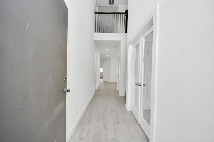 As you step into the threshold of this luxurious home, you'll soon be welcomed by an elegant glass door (to be installed). Inside, soaring ceilings amplify the spaciousness, while the refined wood-look tile flooring and oversized baseboards exude sophistication and charm. Sample photo of completed home with similar floor plan. Actual colors and selections may vary.