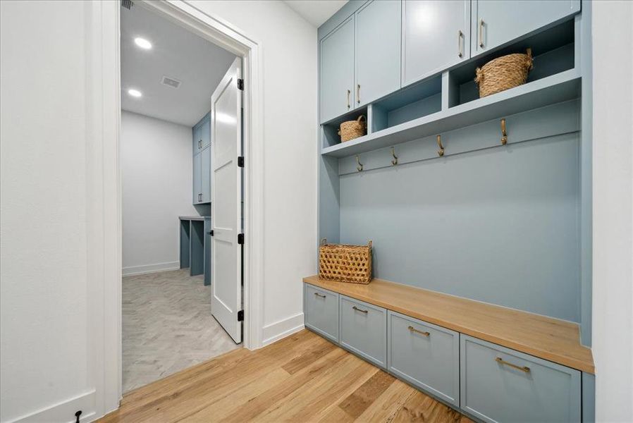 Mudroom with light hardwood flooring