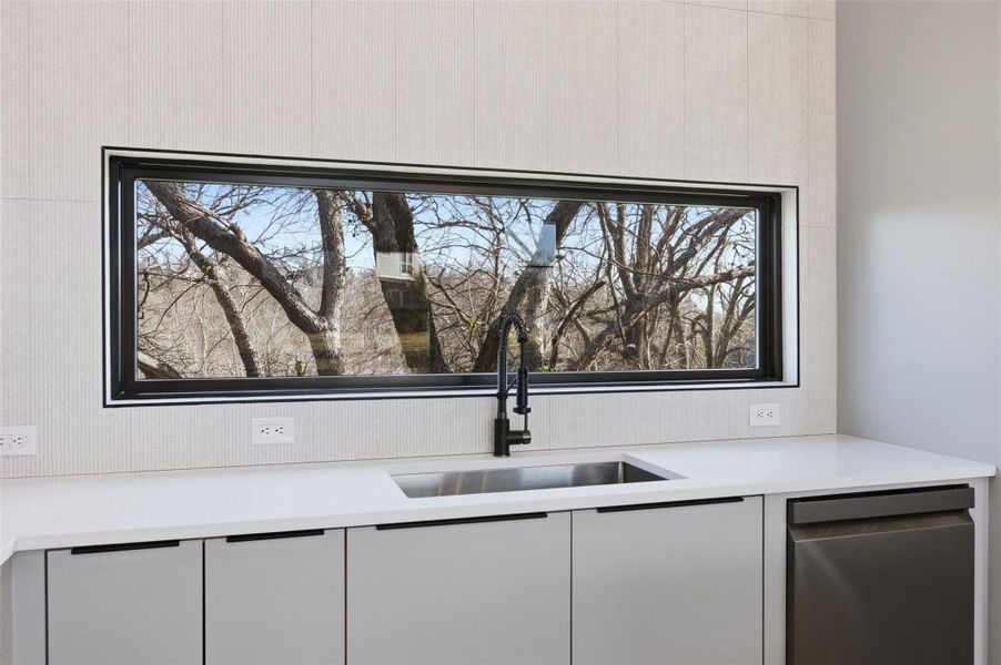 Natural lighting peeking into the kitchen area.