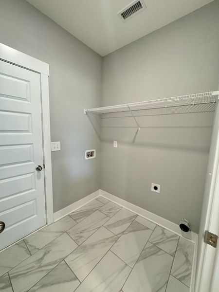 Laundry room with door that leads out to 2 car garage.

*Photo is from a previous listing displaying the completed floor plan some options and selections may vary from actual home.