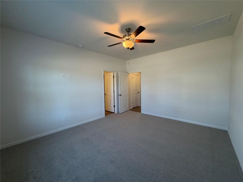Unfurnished bedroom featuring a ceiling fan and carpet floors