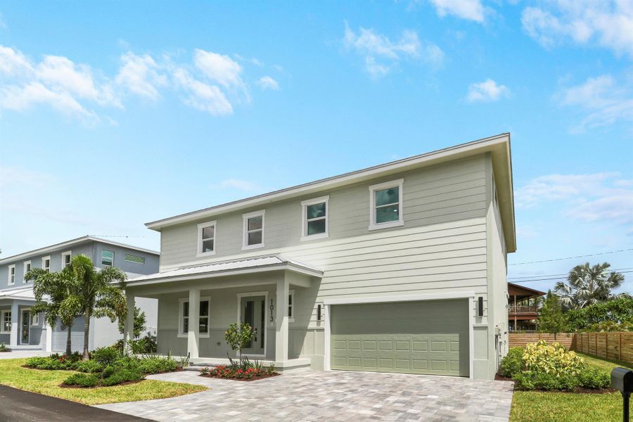 Front exterior of a new home in , Jensen Beach, FL, highlighting curb appeal (Image 1).