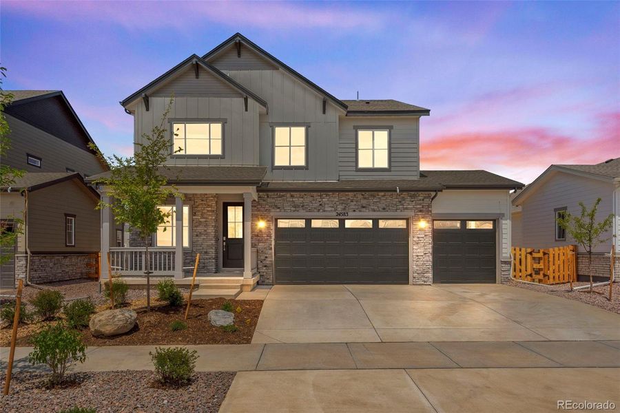 Front exterior of a new home in Prelude at The Aurora Highlands, Aurora, CO, highlighting curb appeal (Image 24). Front exterior of a new home in Prelude at The Aurora Highlands, Aurora, CO, highlighting curb appeal (Image 24).