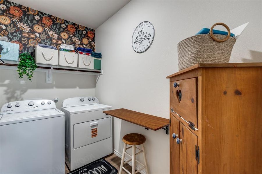 Laundry room with separate washer and dryer and dark wood-style flooring Laundry room with separate washer and dryer and dark wood-style flooring