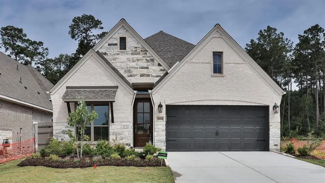 Front exterior of a new home in Artavia 45', Conroe, TX, highlighting curb appeal (Image 1).