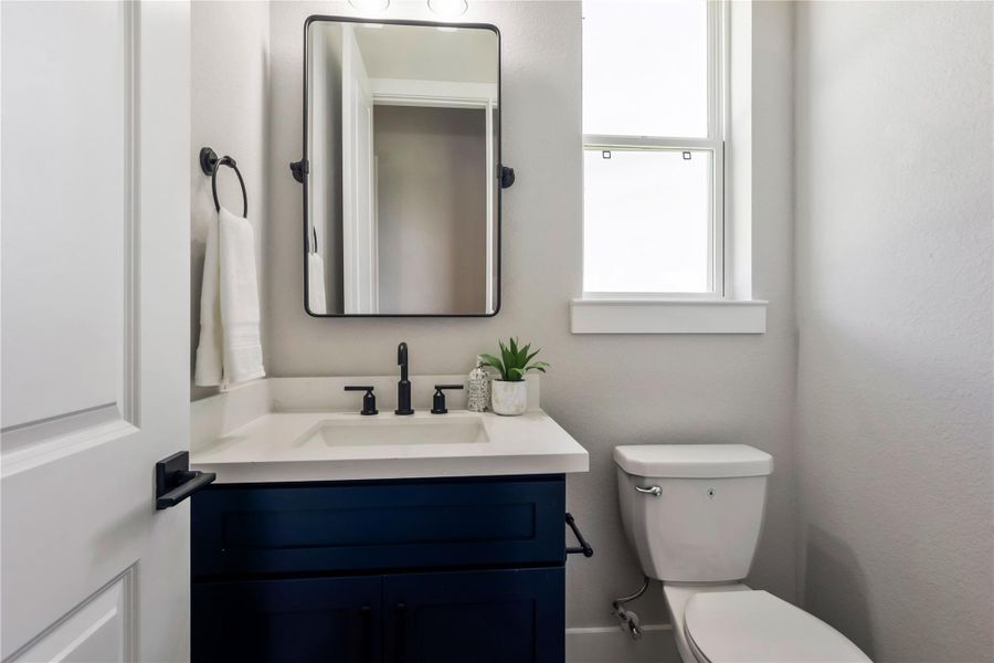 Chic and modern powder room with sleek fixtures and natural light. Chic and modern powder room with sleek fixtures and natural light.