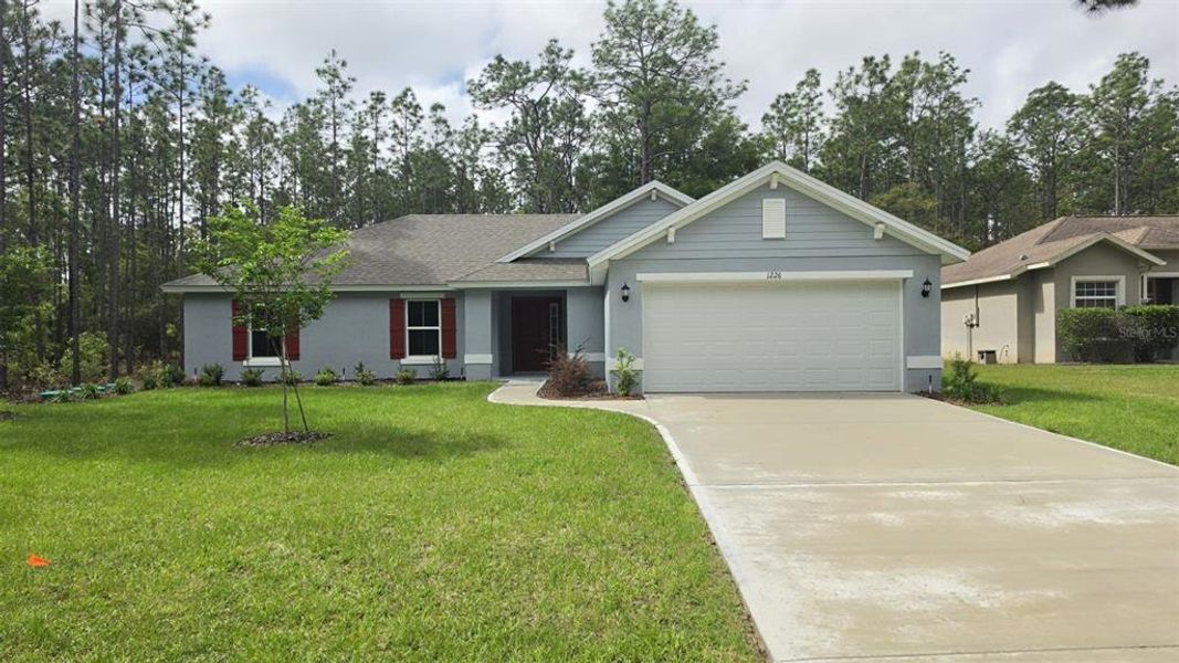 Front exterior of a new home in , Citrus Springs, FL, highlighting curb appeal (Image 14). Front exterior of a new home in , Citrus Springs, FL, highlighting curb appeal (Image 14).