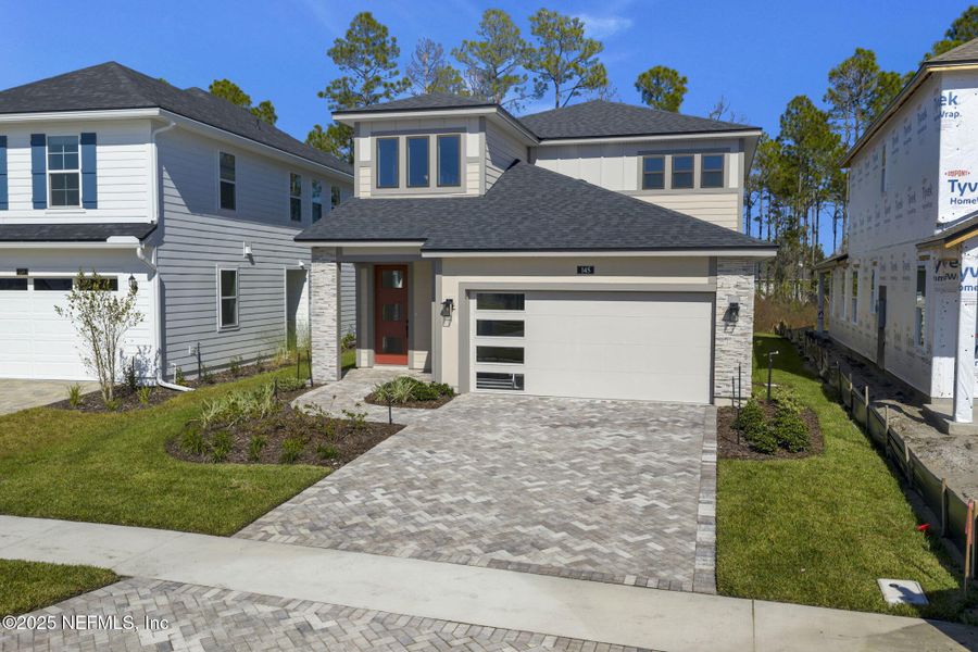 Front exterior of a new home in Crosswinds at Nocatee, Nocatee, FL, highlighting curb appeal (Image 2).