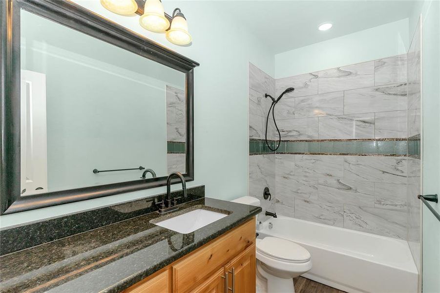 Bathroom featuring  shower combination and vanity