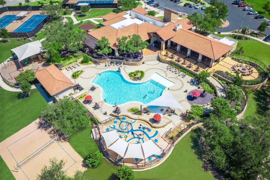 An aerial perspective showcases a comprehensive community recreation complex featuring a resort-style swimming pool.