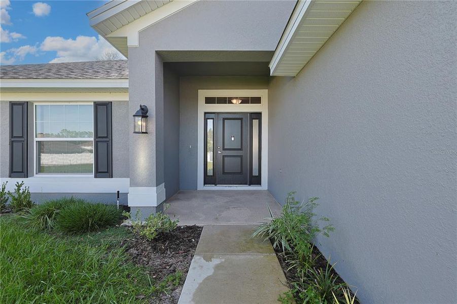 Front exterior of a new home in Ocala Waterway / Kingsland Country Estates, Ocala, FL, highlighting curb appeal (Image 22).