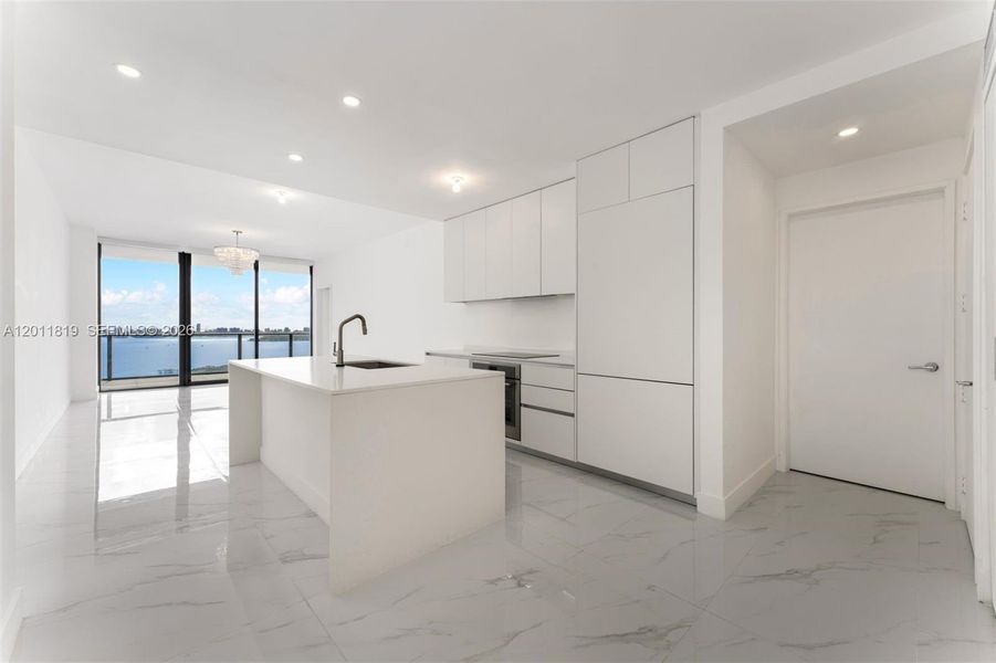 Modern chef’s kitchen equipped with custom Italian cabinetry, premium Miele appliances, integrated stone countertops, and a waterfall island perfect for entertaining.