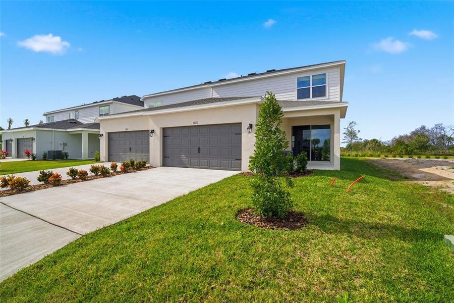 Front exterior of a new home in , Parrish, FL, highlighting curb appeal (Image 1). Front exterior of a new home in , Parrish, FL, highlighting curb appeal (Image 1).