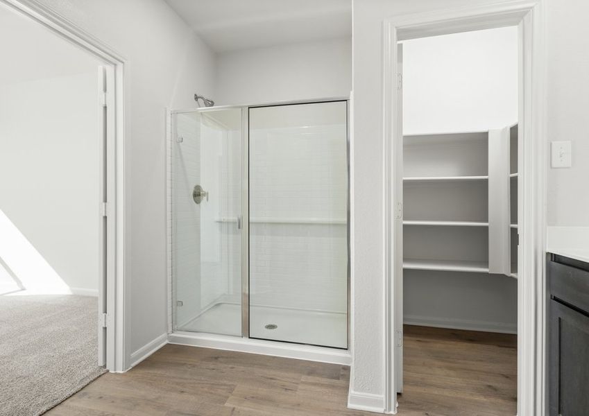 The master bathroom has a glass, walk-in shower.