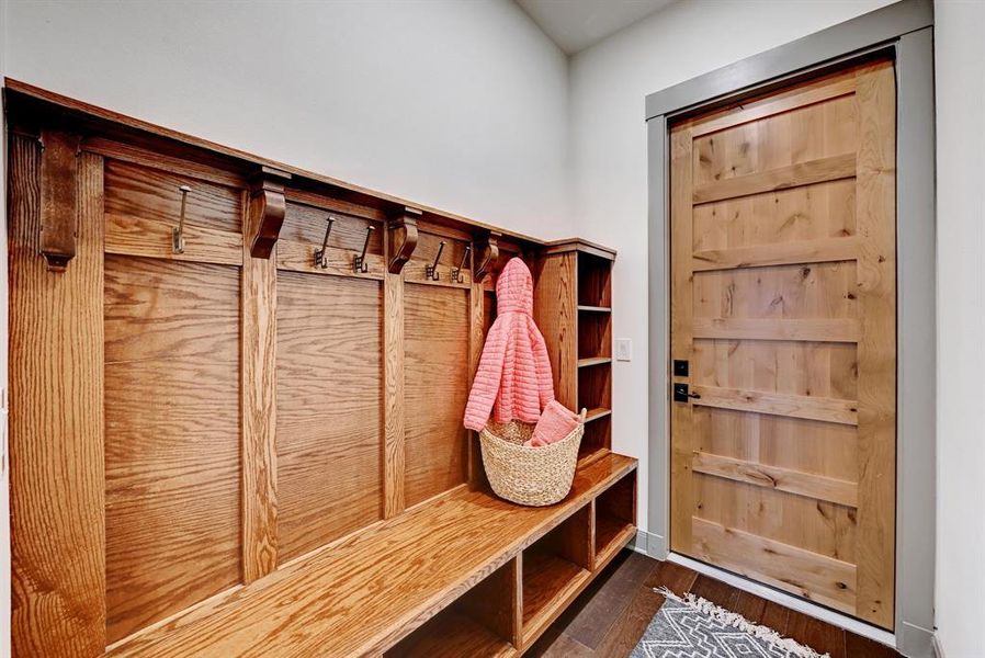 Mudroom featuring dark wood-style flooring and baseboards
