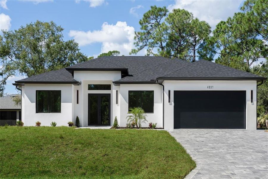 Front exterior of a new home in , North Port, FL, highlighting curb appeal (Image 1). Front exterior of a new home in , North Port, FL, highlighting curb appeal (Image 1).