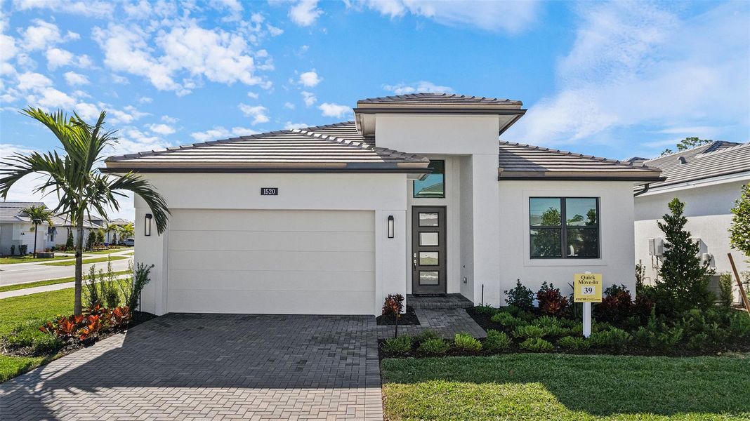 Front exterior of a new home in Cove Royale, Stuart, FL, highlighting curb appeal (Image 2).