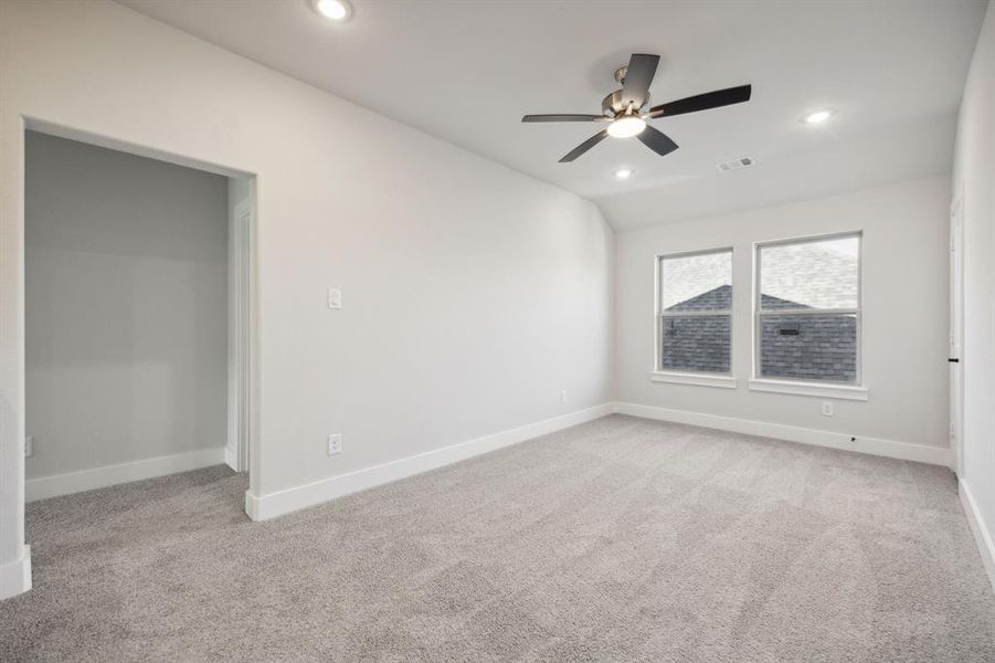 Unfurnished room featuring light colored carpet and ceiling fan