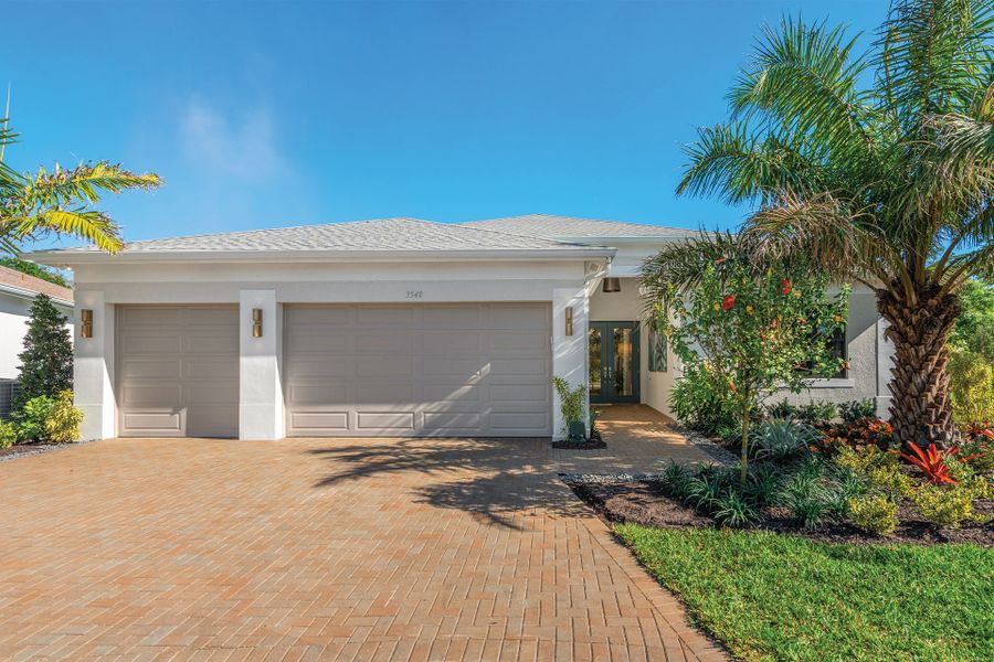 Front exterior of a new home in Valencia Harbor (55+), Fort Myers, FL, highlighting curb appeal (Image 1). Front exterior of a new home in Valencia Harbor (55+), Fort Myers, FL, highlighting curb appeal (Image 1).