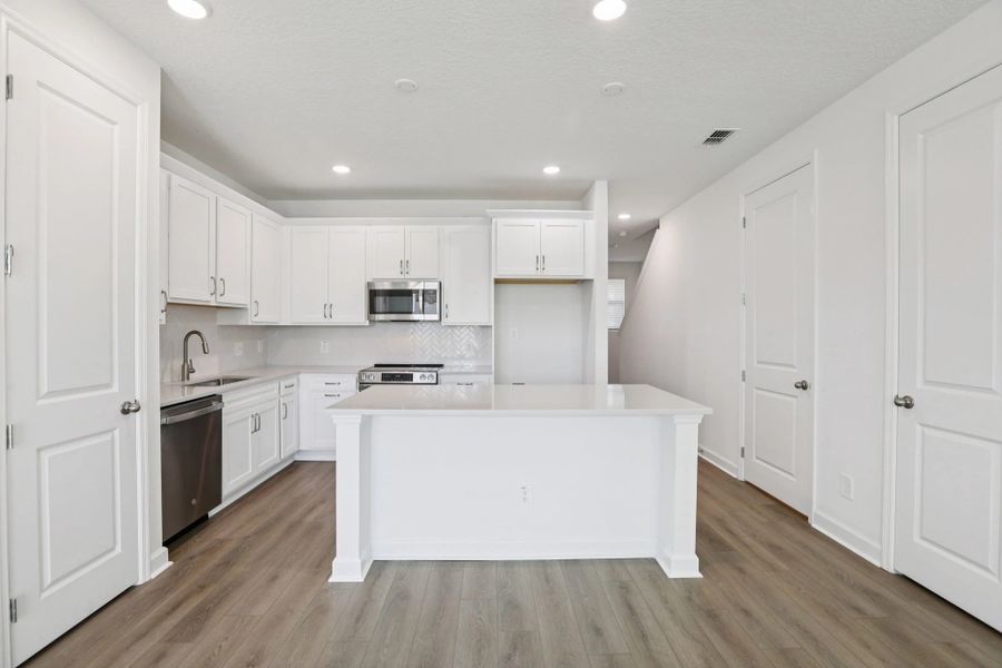 Kitchen also features a large kitchen island ideal for entertaining or weeknight dinners
