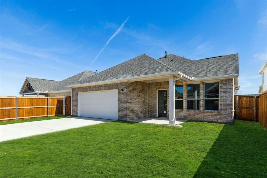 Ranch-style home with a garage and a front lawn