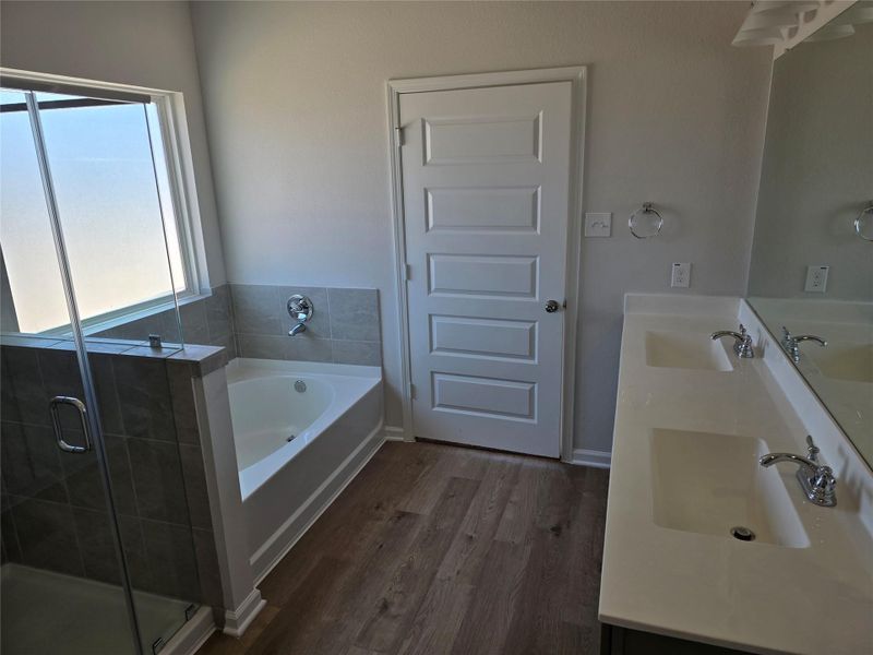 The Shetland III- Primary Bathroom with garden tub and dual sinks. Home under construction. Sample floor plan photo used for illustrative purposes only. Upgrades, selections options, windows and colors may vary. The Shetland III- Primary Bathroom with garden tub and dual sinks. Home under construction. Sample floor plan photo used for illustrative purposes only. Upgrades, selections options, windows and colors may vary.