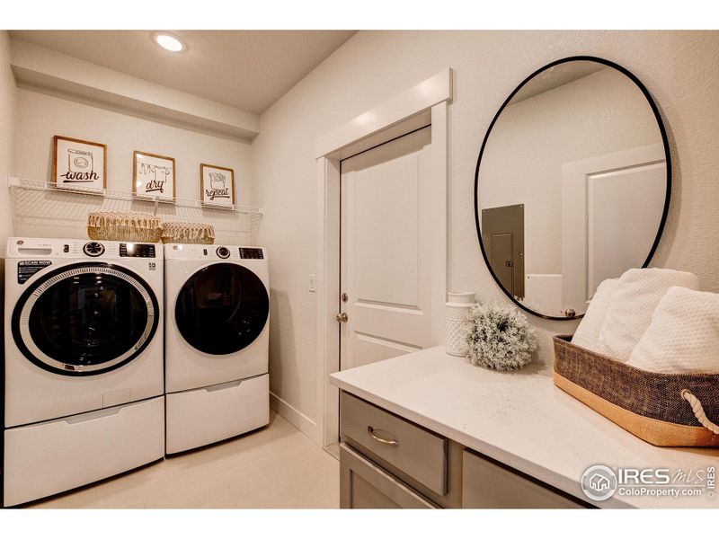 Laundry room w/ built in cabinets for storage & folding