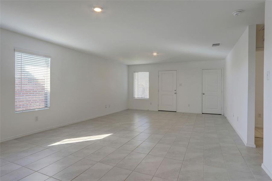 Empty room featuring light tile patterned flooring and recessed lighting