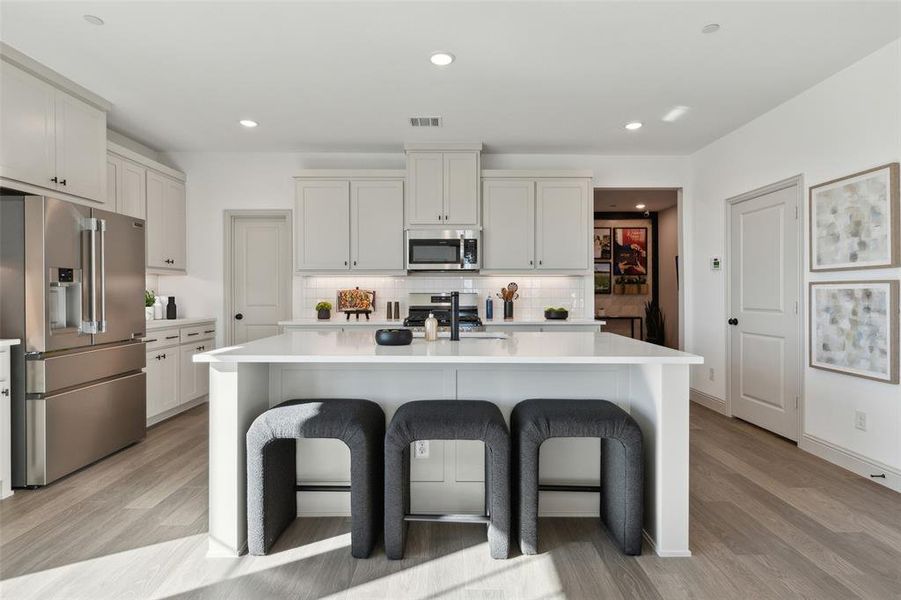 The large kitchen island creates the perfect gathering place for family and friends!