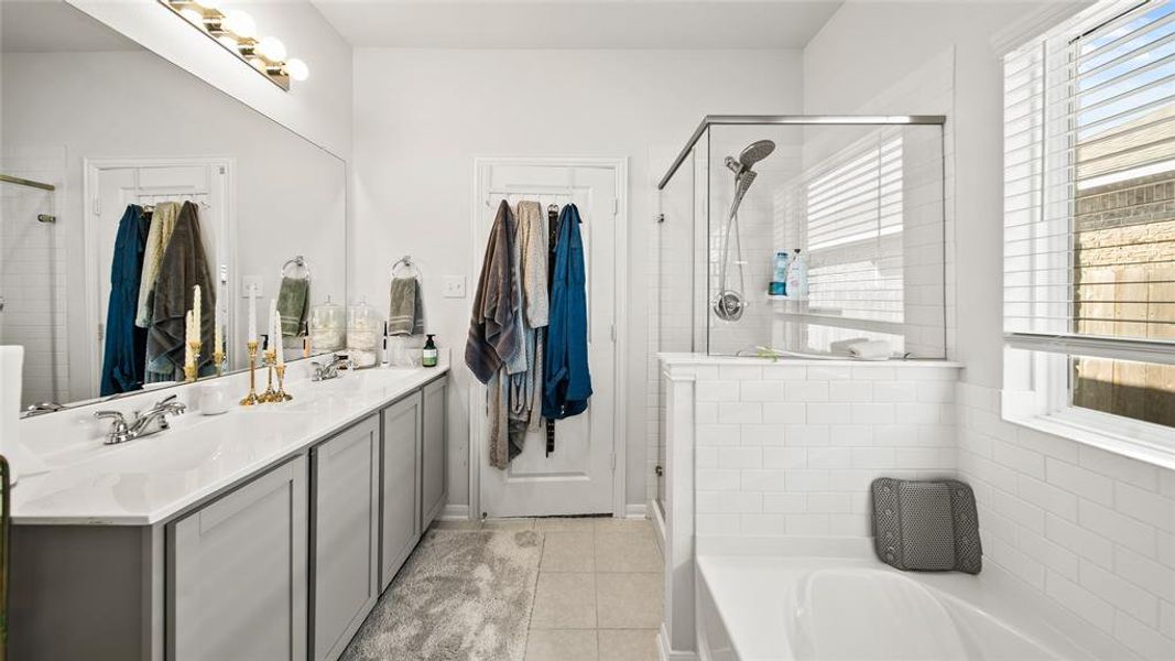 Double vanity it the primary bath with lots of cabinet space.