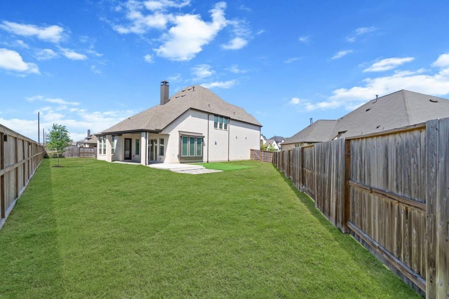 Outdoor living at its finest! This extended patio with extended pavers and turf is perfect for relaxing or entertaining year-round. Just add good company and enjoy!