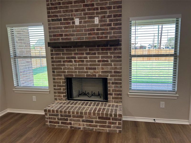 Detailed view of a fireplace and wood finished floors