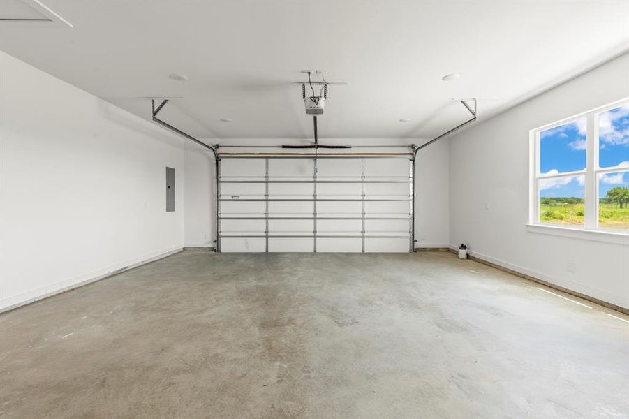 Garage with electric panel and a garage door opener