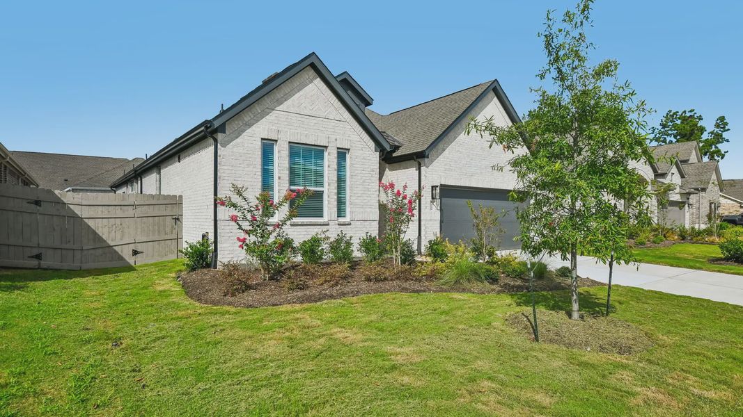 Front exterior of a new home in Artavia, Conroe, TX, highlighting curb appeal (Image 23).