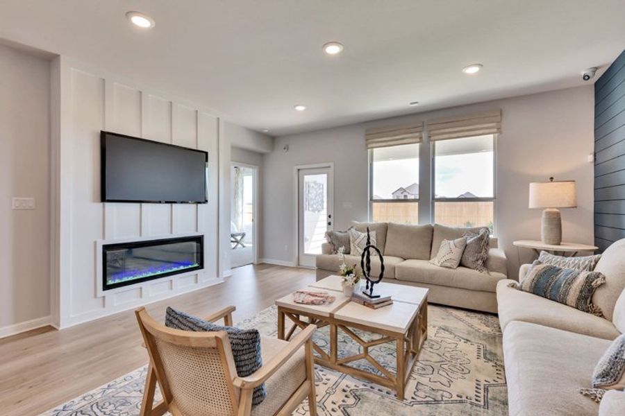 A living room with a tv and couches. A living room with a tv and couches.