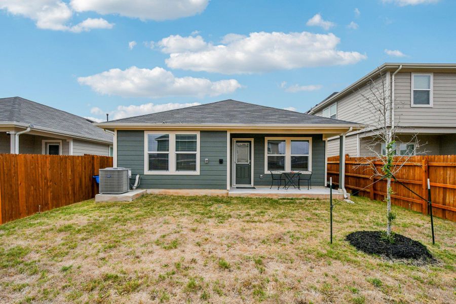 Back of property featuring a patio and a fenced backyard