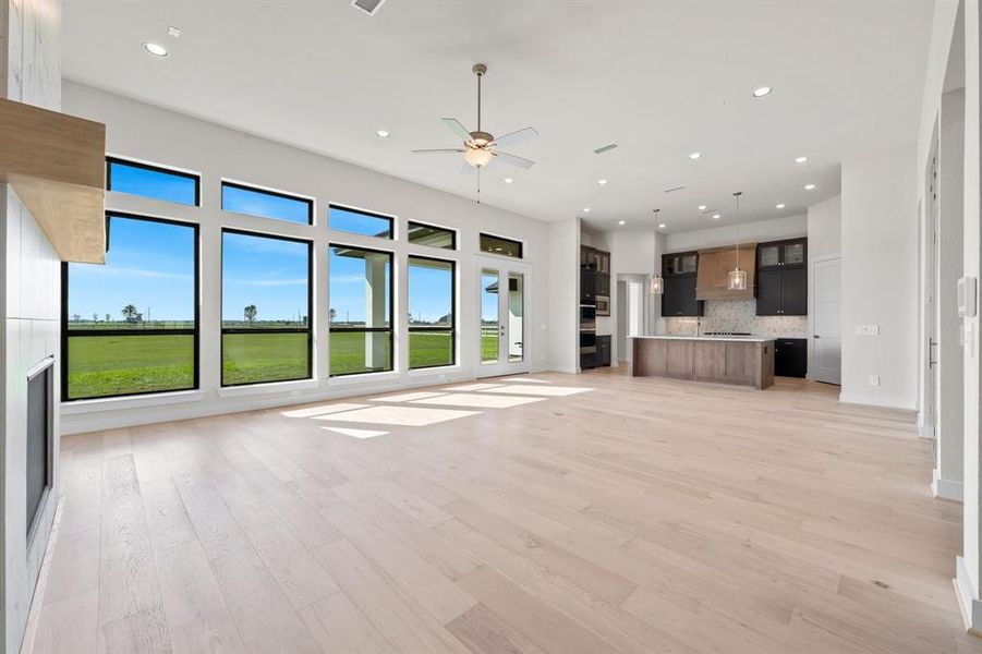 Enjoy the vast view of your property with a wall of windows from the Family Room to the Dining Area and Kitchen to take it all in.