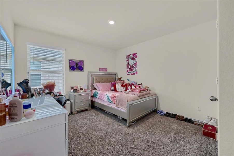 Bedroom with light carpet and recessed lighting
